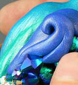 Clay peacock with glass beads